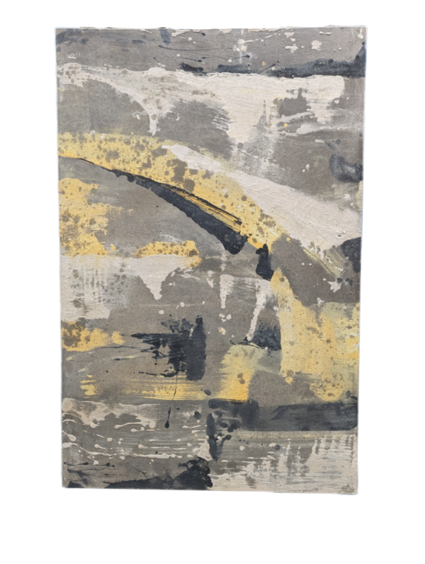 A painting on canvas. Paint splatter in different shades of grey with some yellow patches.