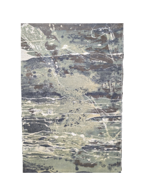 A painting on canvas. Paint is splattered across the canvas in shades of white, green and blue to create a unique image.