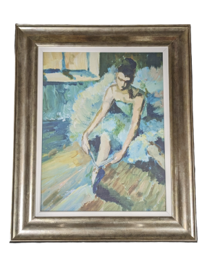 A print of a modern oil painting depicting a ballerina tying her shoe ribbons. The print is in a large chunky frame.