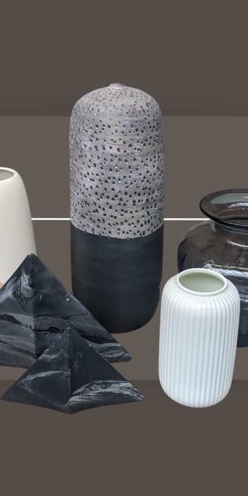 a display of on-trend ceramics and vases. There are five vases in varying natural colours against a grey background.